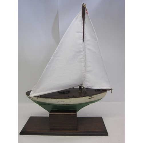 8434 - A scratch built wooden pond yacht with green and white painted hull and lead weighted keel, later wh... 