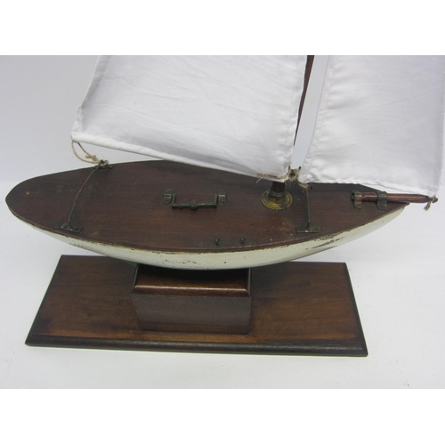 8434 - A scratch built wooden pond yacht with green and white painted hull and lead weighted keel, later wh... 