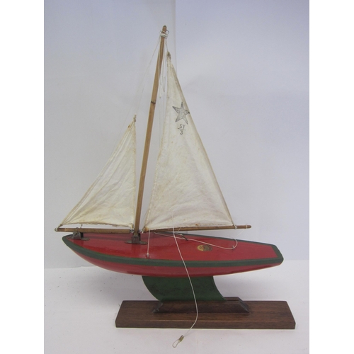 8442 - A Star SY3 wooden pond yacht on stand with original cloth sails, hull repainted, 48cm tall