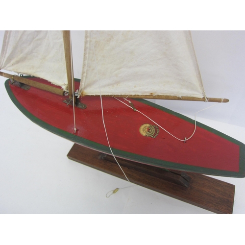 8442 - A Star SY3 wooden pond yacht on stand with original cloth sails, hull repainted, 48cm tall