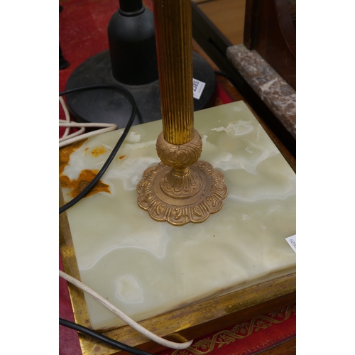 2173 - A brass and onyx standard lamp and a lounge lamp with articulating neck