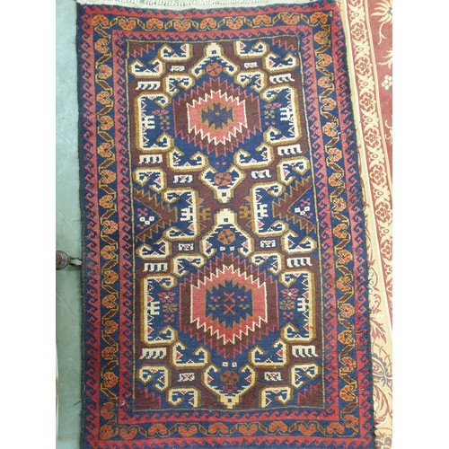 2450 - A rust coloured carpet 277cm x 190cm and an Eastern rug three guls, maroon ground, 135cm x 84cm (2)