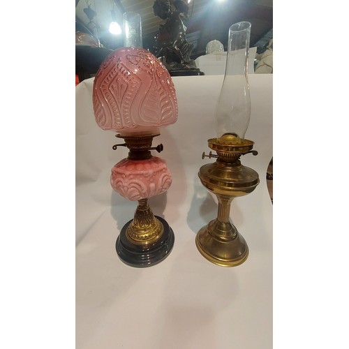 4034 - Two oil lamps, one in pink with matching shade and one other (2)
