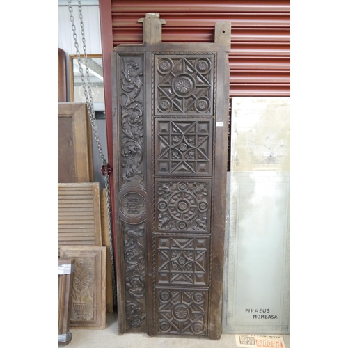 2104 - A heavily carved panel dated 1868,  178 x 65cm