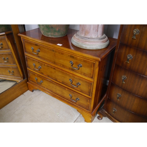 2112 - A modern yew wood chest of three drawers