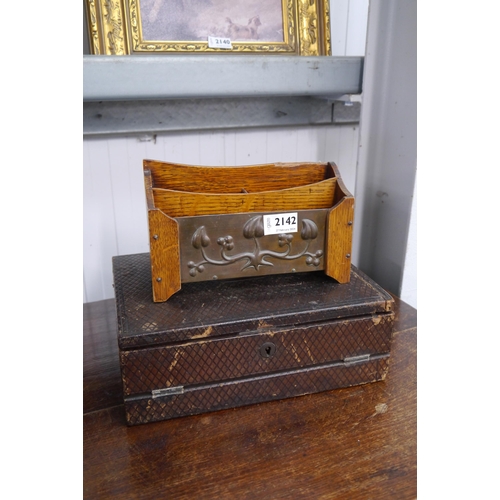 2142 - An Arts an Crafts oak letter rack with embossed copper front, chip to top and a writing box