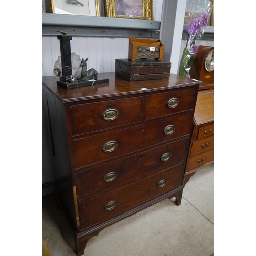 2143 - A George III country oak chest of two short over three long drawers, brass oval handles, on bracket ... 