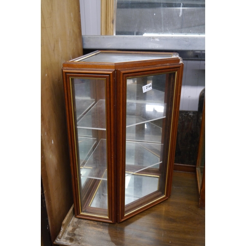 2166 - A glazed corner wall cupboard, mirrored base, two glass shelves