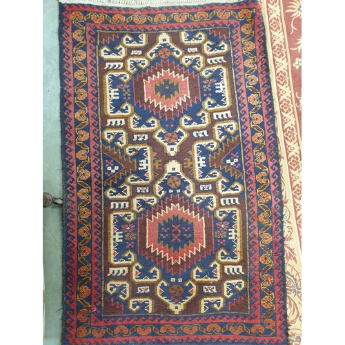 2450 - A rust coloured carpet 277cm x 190cm and an Eastern rug three guls, maroon ground, 135cm x 84cm (2)