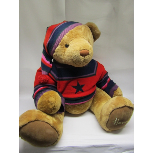 8283A - A very large Harrods shop display teddy bear wearing knitted jumper and hat (approx. 90cm tall when ... 