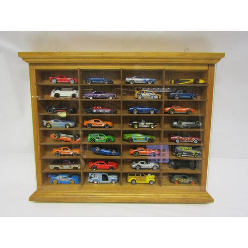 8160 - A collectors wall mounting display cabinet (34.5cm x 44.5cm) housing a collection of thirty-two Matc... 