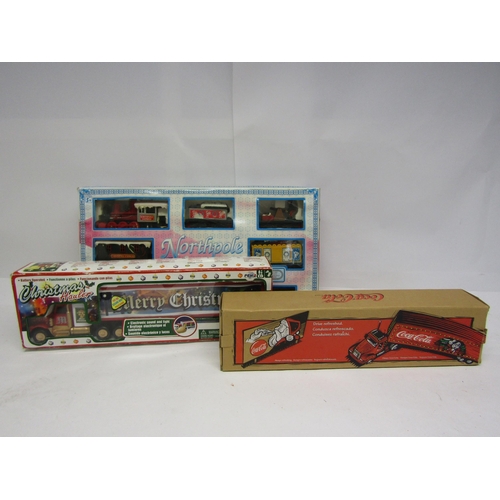 8192 - Three boxed Christmas themed plastic toys to include Freightliner Coca-Cola lorry, Peha Christmas Ha... 