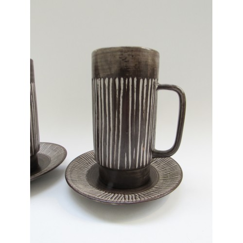 9128 - A pair of Einer Hellevoe BR keramik chocolate cups and saucers with vertical line detail. Cups 16cm ... 