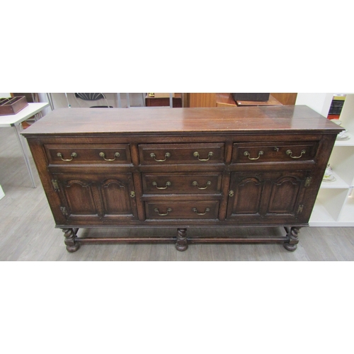 1057 - A Muirhead Moffat & Co., Glasgow, Georgian style oak sideboard with three central drawers flanked by... 