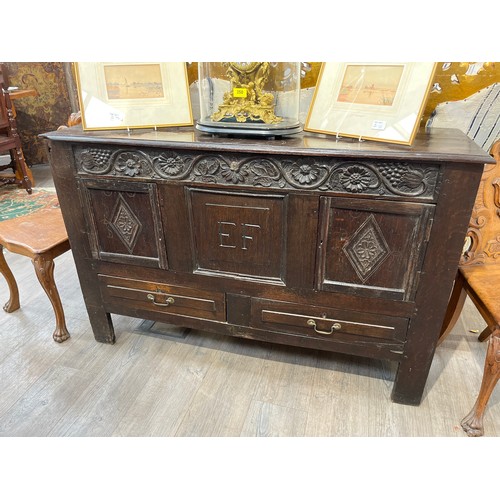 1100 - Monogrammed EF a Georgian oak mule chest, two drawers and decorative floral frieze with elements mis... 