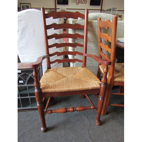 1133 - An 18th Century style circular top gateleg dining table, the rising leaves over turned legs joined b... 