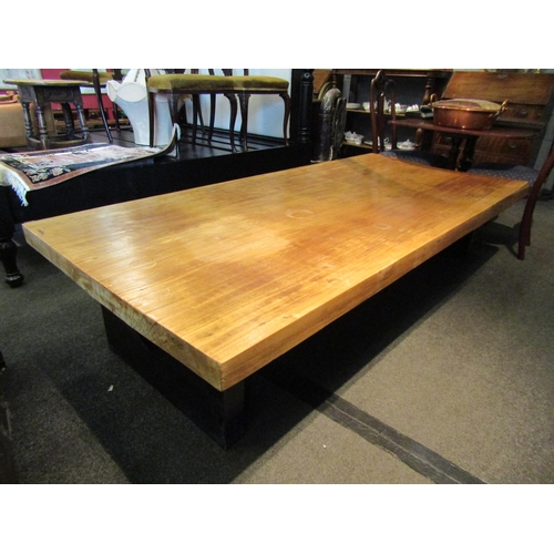 1154 - A hardwood coffee table on black painted base, 48cm tall x 214cm long x 96cm wide