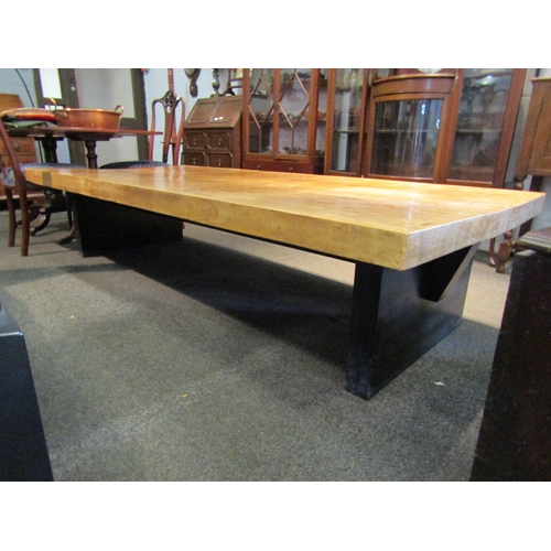 1154 - A hardwood coffee table on black painted base, 48cm tall x 214cm long x 96cm wide