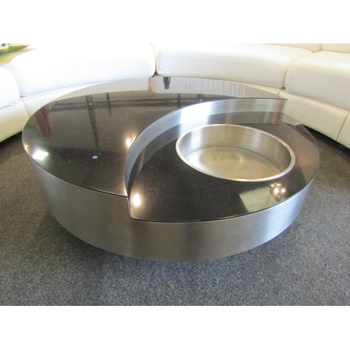 1158 - A contemporary black marble circular swivel coffee table, stainless steel finish with recess and lif... 