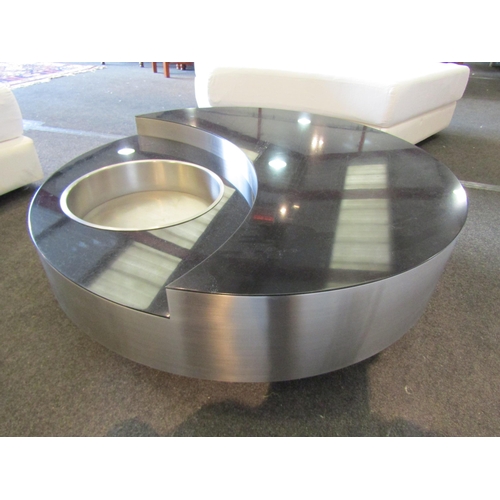 1158 - A contemporary black marble circular swivel coffee table, stainless steel finish with recess and lif... 