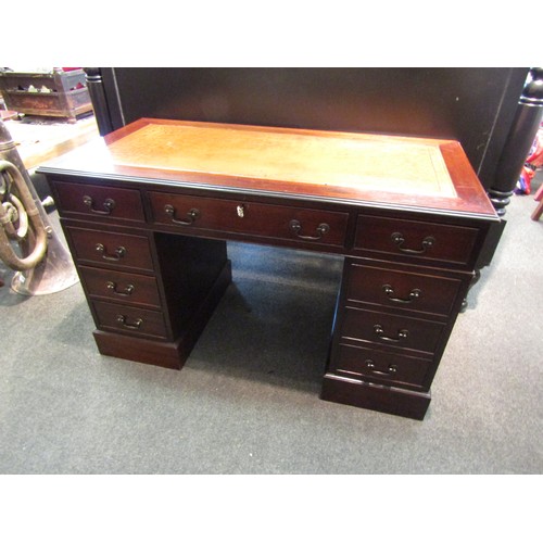 1166 - A George III style twin pedestal desk, the gilt tooled leather insert over eight drawers and plinth ... 