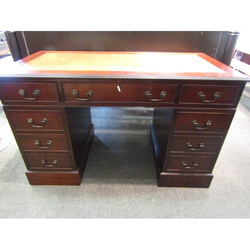 1166 - A George III style twin pedestal desk, the gilt tooled leather insert over eight drawers and plinth ... 