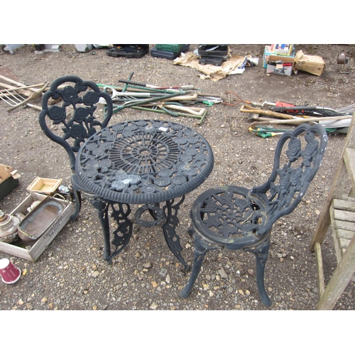 3588 - A cast rose pattern table with two chairs