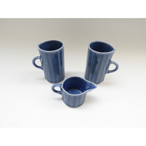 9046 - Two studio pottery mugs and a jug, each signed with potters AJC mark to base. Tallest 12cm  