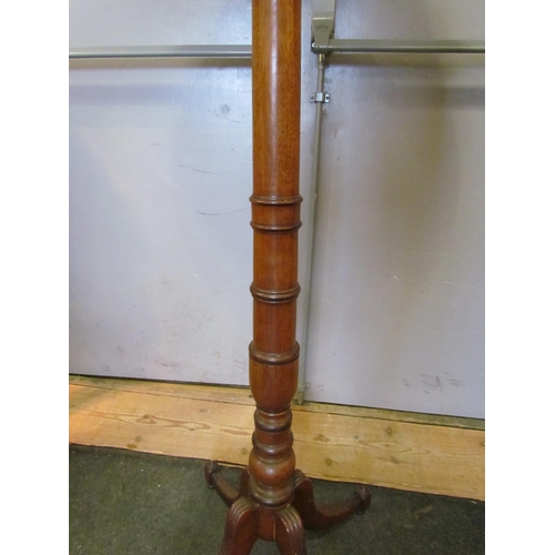 1004 - A 20th Century turned mahogany standard lamp on quatreform base with pleated shade