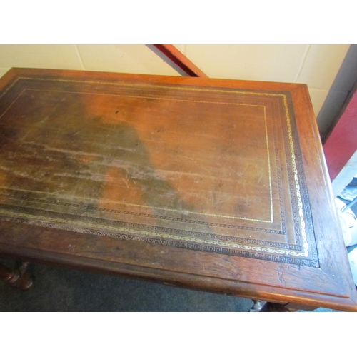 1008 - An early 20th Century desk, the tooled leather top over two frieze drawers, turned supports joined b... 