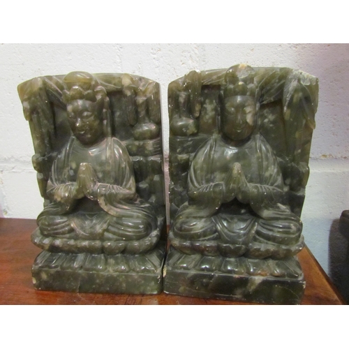 1044 - A pair of Oriental hardstone bookends of deity form, one chipped, 18cm tall