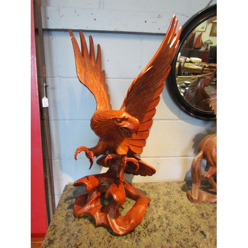 1106 - A carved wooden figure of an eagle, 77cm tall