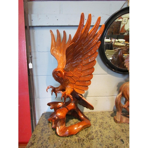 1106 - A carved wooden figure of an eagle, 77cm tall