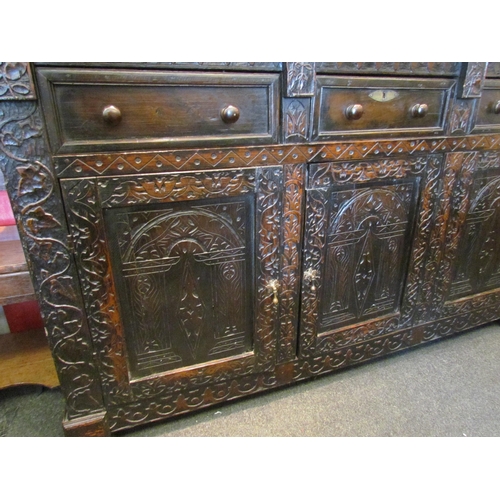 1107 - A Victorian carved oak dresser base with later marble top over three drawers and three door cupboard... 