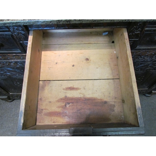 1107 - A Victorian carved oak dresser base with later marble top over three drawers and three door cupboard... 