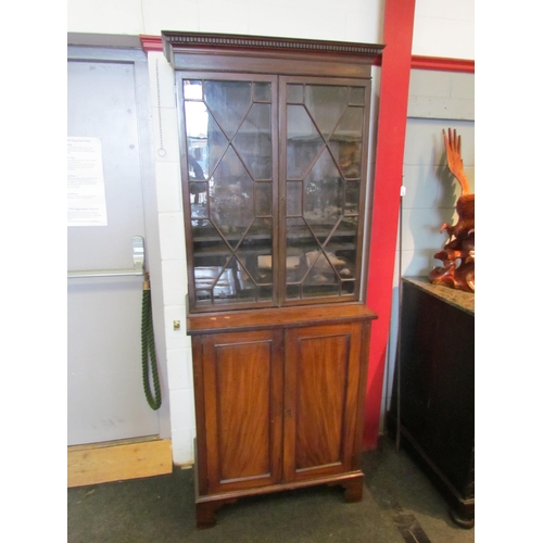 1111 - A Regency mahogany bookcase, the astragal glazed top over a two door cupboard base, split to top, 20... 