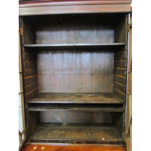 1111 - A Regency mahogany bookcase, the astragal glazed top over a two door cupboard base, split to top, 20... 