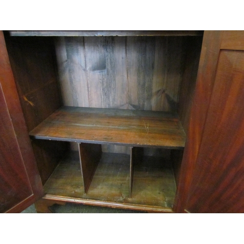 1111 - A Regency mahogany bookcase, the astragal glazed top over a two door cupboard base, split to top, 20... 