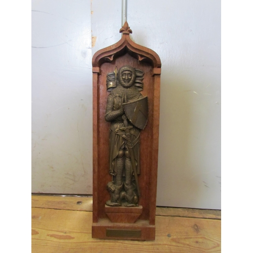 1115 - A memorial brass on oak display plaque depicting a knight, 66cm tall