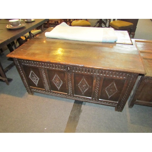 1116 - A late 17th / early 18th Century country oak coffer, plank top over four carved panel front, stile f... 