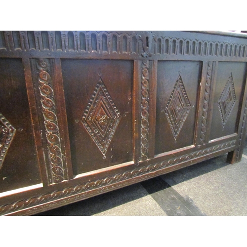 1116 - A late 17th / early 18th Century country oak coffer, plank top over four carved panel front, stile f... 