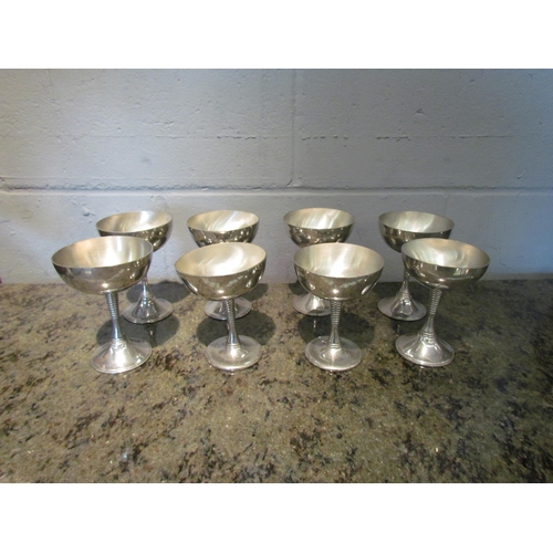 1120 - Eight pewter champagne saucers, ribbed stems, made in Ireland (one dented)