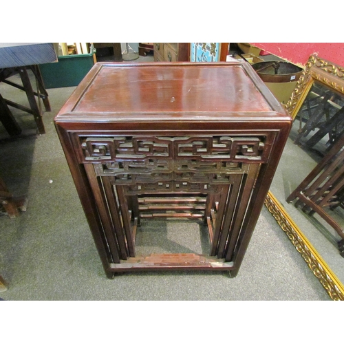 1123 - A 19th Century Chinese hardwood nest of four tables, geometric frieze, largest 66cm tall x 47cm wide... 