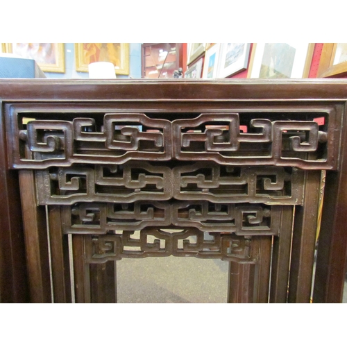 1123 - A 19th Century Chinese hardwood nest of four tables, geometric frieze, largest 66cm tall x 47cm wide... 