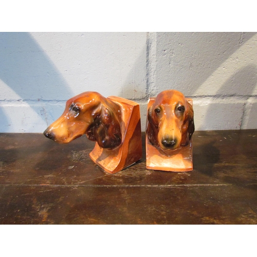 1125 - A pair of ceramic bookends in the form of Spaniel heads, one a/f, and a ceramic figure of a peacock ... 