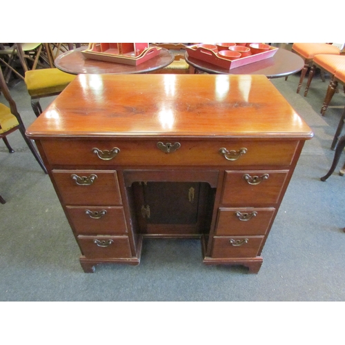 1127 - A Victorian mahogany kneehole desk, single drawer over cupboard door flanked by drawers, 76cm tall x... 