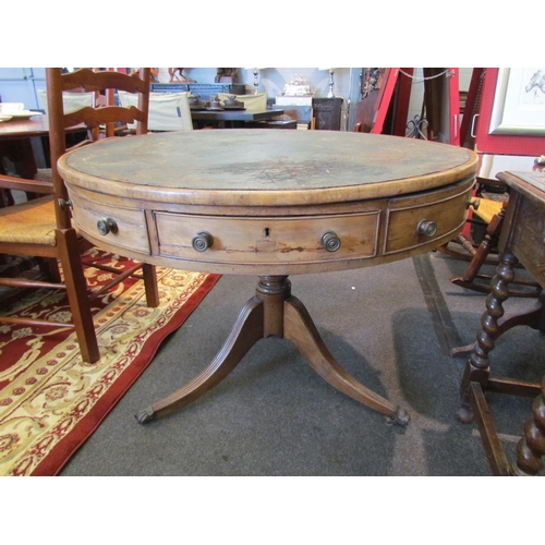 1136 - A Regency mahogany drum form table, the gilt tooled leather inset top over frieze drawers, on quatre... 