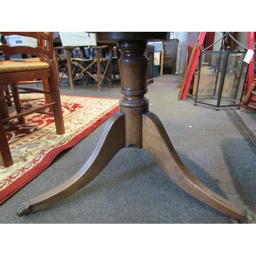 1136 - A Regency mahogany drum form table, the gilt tooled leather inset top over frieze drawers, on quatre... 