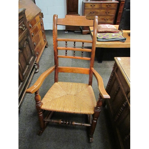 1137 - A part elm and wicker rocking chair with ebonised spindle back support