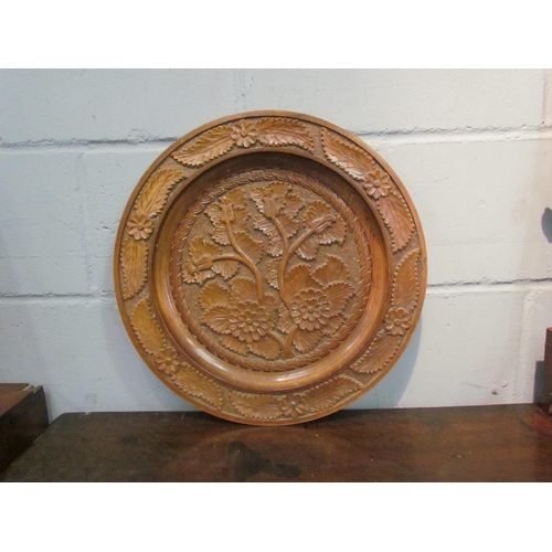 1138 - A carved wooden dish with floral design, 44cm diameter